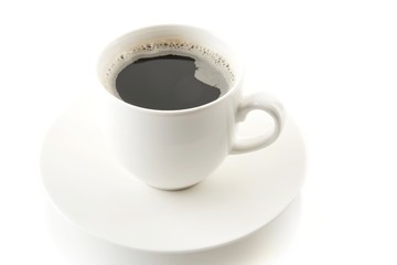 Cup of coffee with saucer on white