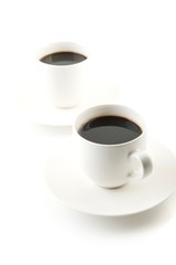 Cups of coffee with saucer on white