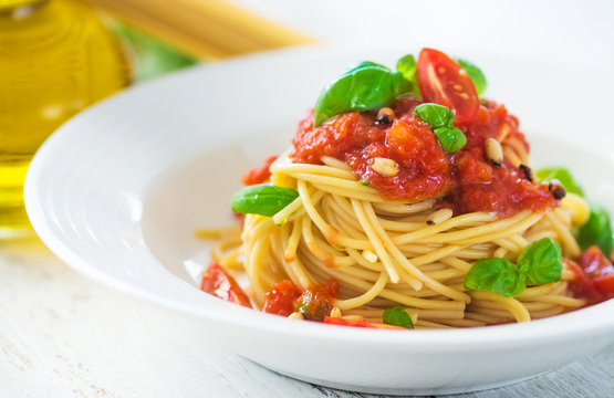 Spaghetti with tomato and basil leaves and chilli