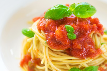 Spaghetti with tomato and basil leaves and chilli