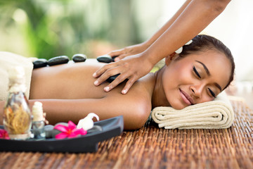 Obraz na płótnie Canvas Young attractive woman enjoying in Asian massage
