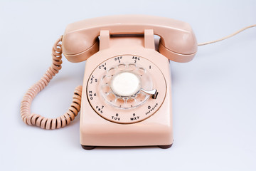 Isolated cream or beige rotary telephone