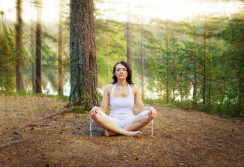 Woman meditate in the forest