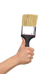 Woman hand with paint brush with plastic wooden handle