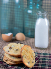 Stack of chocolate chip cookies with milk.  