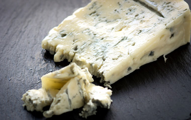 Gorgonzola cheese on black background - obrazy, fototapety, plakaty