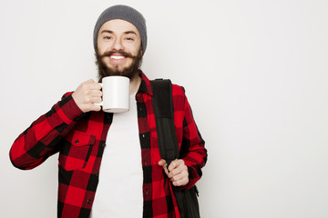 young bearded man with a cup of coffee