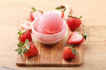 red strawberry ice cream scoop with fresh strawberry