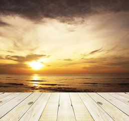 Fototapeta na wymiar Wood terrace and Cloudy orange sunset over sea
