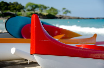 Colorful outriggers, canoes and boards at Kaunaoa beach