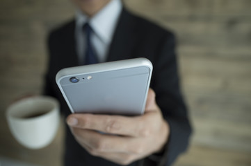 Businessman has a telephone and a coffee