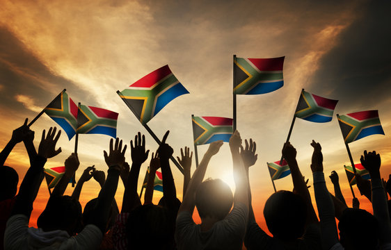 Group Of People Waving South African Flags In Back Lit