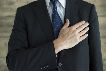 Businessman is place your hand on the chest