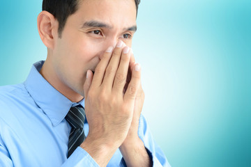A man sneezing without tissue or cloth that may spread disease