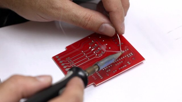 Man soldering electronic parts - closeup