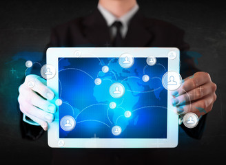 Young person holding talbet with communication technology concep