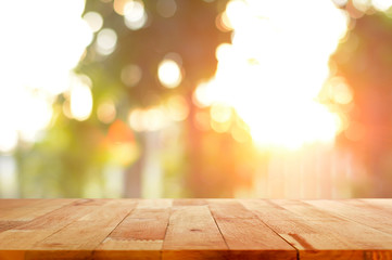 Naklejka na ściany i meble Wood table top on shiny sunlight bokeh background