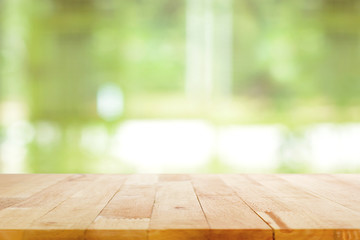 Wood table top on blurred green background