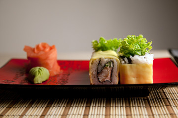 Fototapeta na wymiar Sushi rolls on a red plate