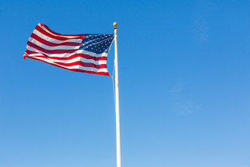 American flag against blue sky.