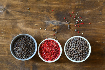 Peppercorn mix. Red, black and green peppers in bowls