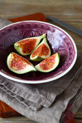 Sweet pieces of figs in a bowl on napkin