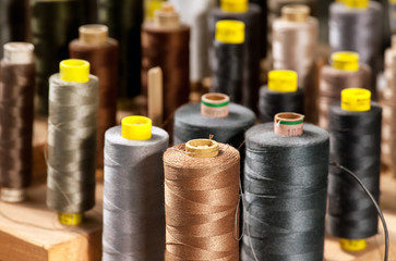 Various colored yarns on bobbins at a tailor