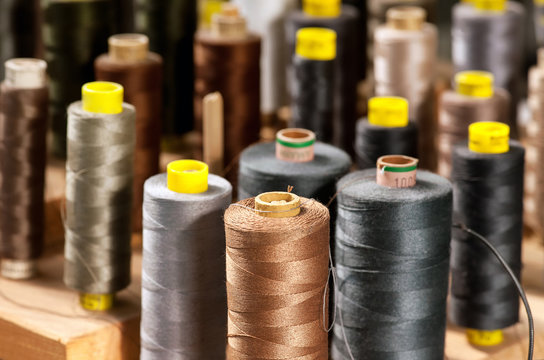 Various colored yarns on bobbins at a tailor