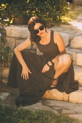 beautiful girl sitting on stairs in park