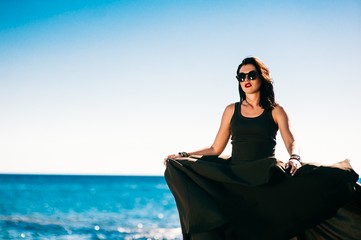 beautiful fashionable model on the beach in beautiful long dress