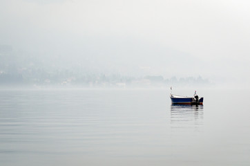 Boat on a lake with misty air