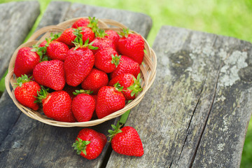 basket with strawberries on a wooden table