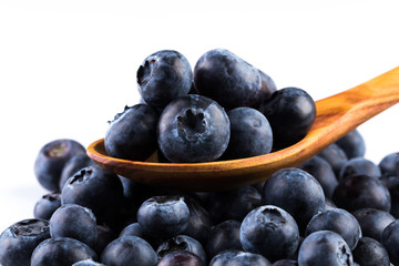Fresh blueberries in wooden spoon