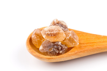 brown caramelized sugar in a wooden spoon