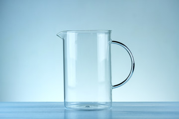 Glass jug on a blue background