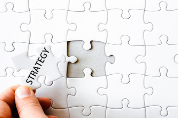 Fototapeta premium Missing jigsaw puzzle piece with word STRATEGY