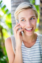 Pretty blonde woman calling on the phone