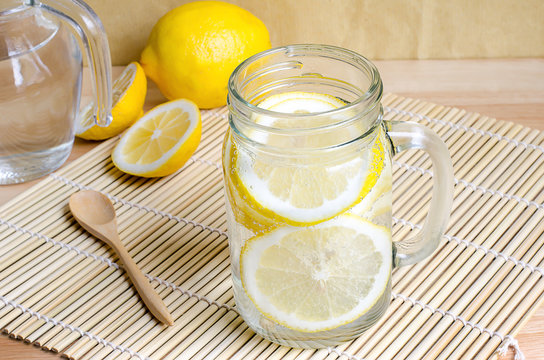 Soda with lemon in jar on wooden table