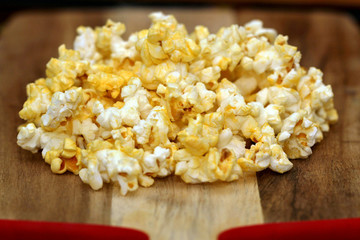 Popped popcorn on wood background