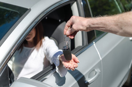 Man giving car key to a woman