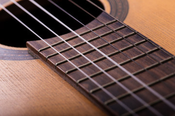 Closeup of old guitar body with sound hole and strings