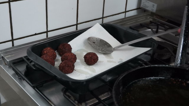 Making falafel in hot oil