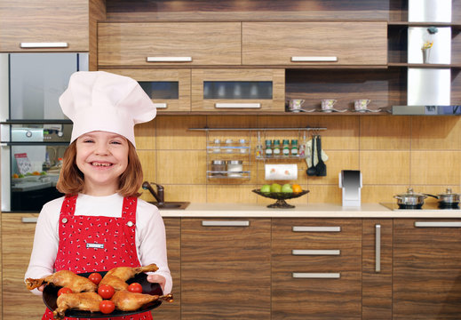 little girl cook with chicken drumstick in kitchen