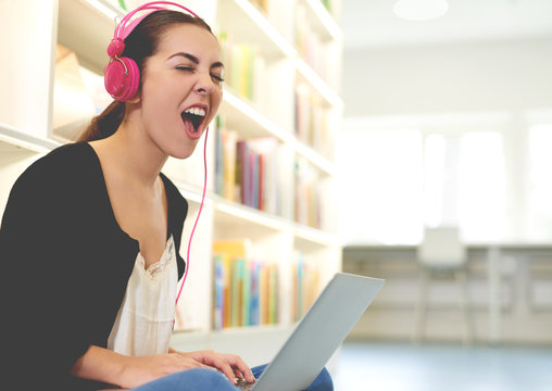 Funny happy student listening to loud music