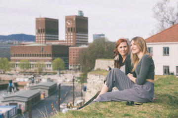 Two beautiful nordic girls enjoying their spare time in Oslo - obrazy, fototapety, plakaty