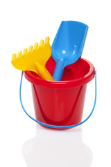 Toy bucket rake and spade isolated on white background