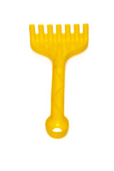 Yellow rake toy isolated on white background 