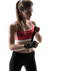 Young fit girl woman applying black boxing bandages