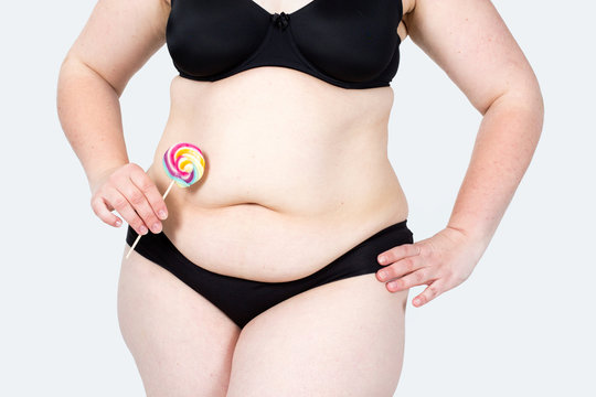 
Woman showing her fat body and holding a lollipop. Healthy lifestyles concept and diet.
Obese neglected body isolated over white background.