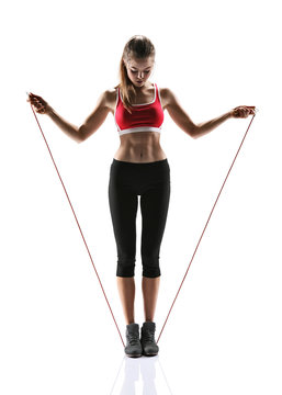 Young woman doing exercise with a skipping rope 